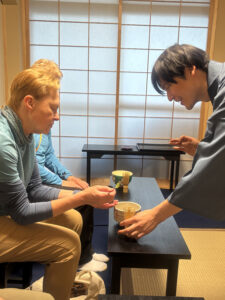 Image of tea ceremony with two US tourists in Japan