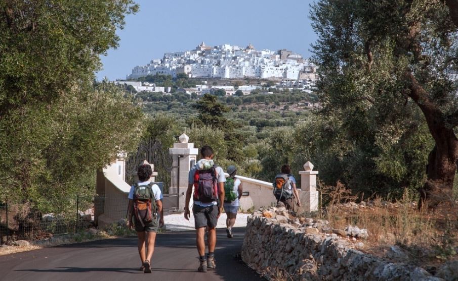 Hikers head towards city in the distance