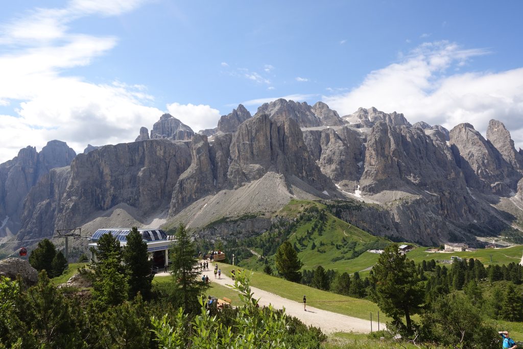 A cabin in the midground, Dolomites mountains in the background