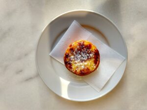 Portuguese pastel de natal on a white plate