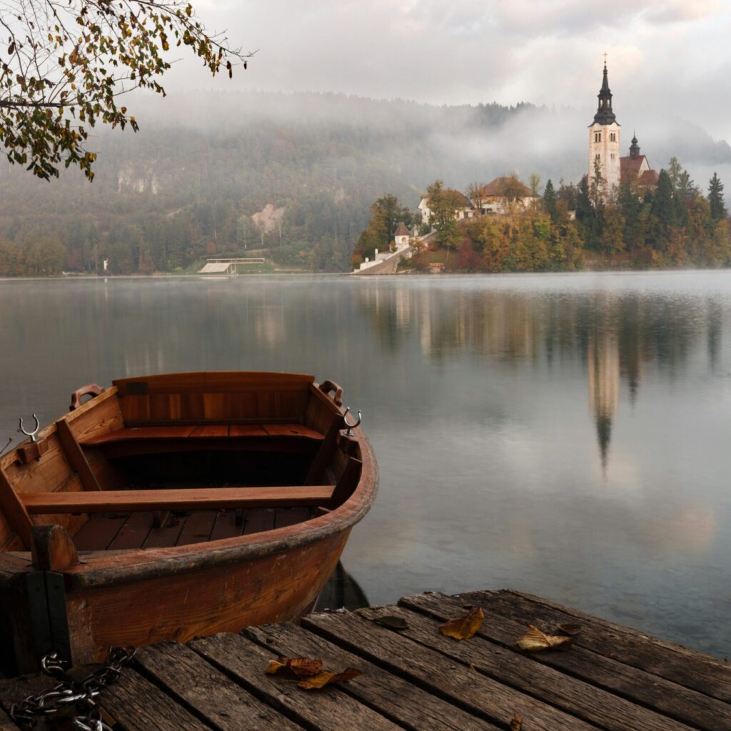 A boat sits beside a dock, with a castle in the distance