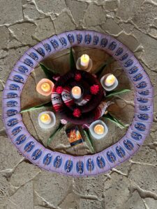 Photo of oracle cards surrounding candles and flowers in preparation for circle